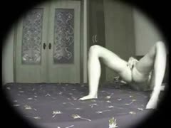 On a concealed camera, a very attractive woman tenderly masturbates her pussy with her fingers.